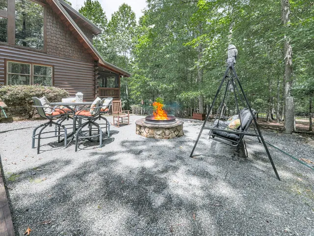 a backyard of a house with table and chairs