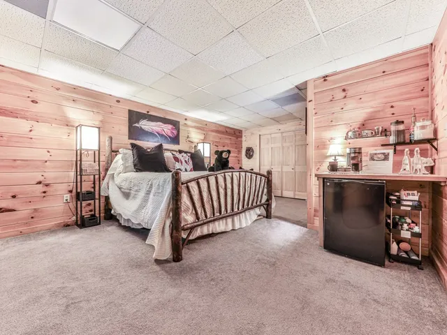 a spacious bedroom with a bed and a cabinets