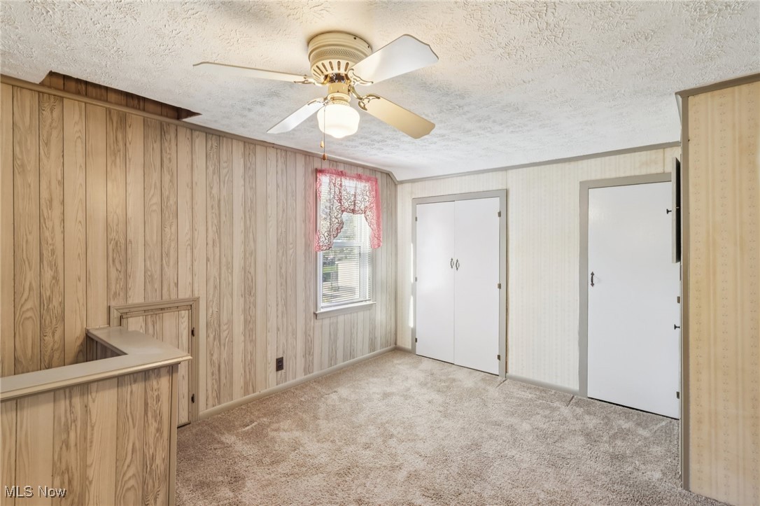 6235 Jefferson Road Ashtabula, OH 44004 - Photo 27 of 40 Unfurnished bedroom with light colored carpet, a closet, a textured ceiling, and ceiling fan