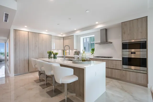 a large kitchen with a table and chairs