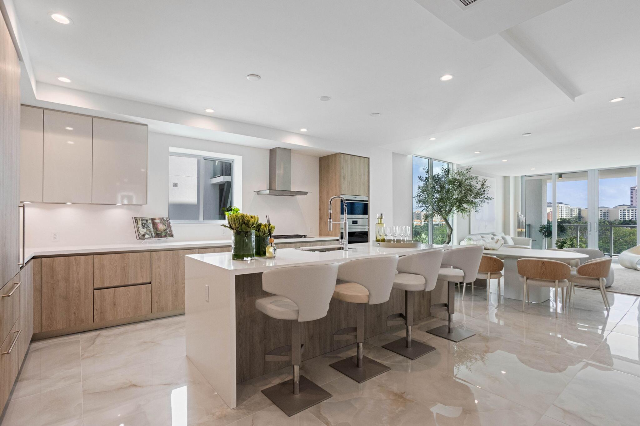 475 East Royal Palm Road, Unit 605 Boca Raton, FL 33432 - Photo 12 of 62 a large kitchen with a table and chairs