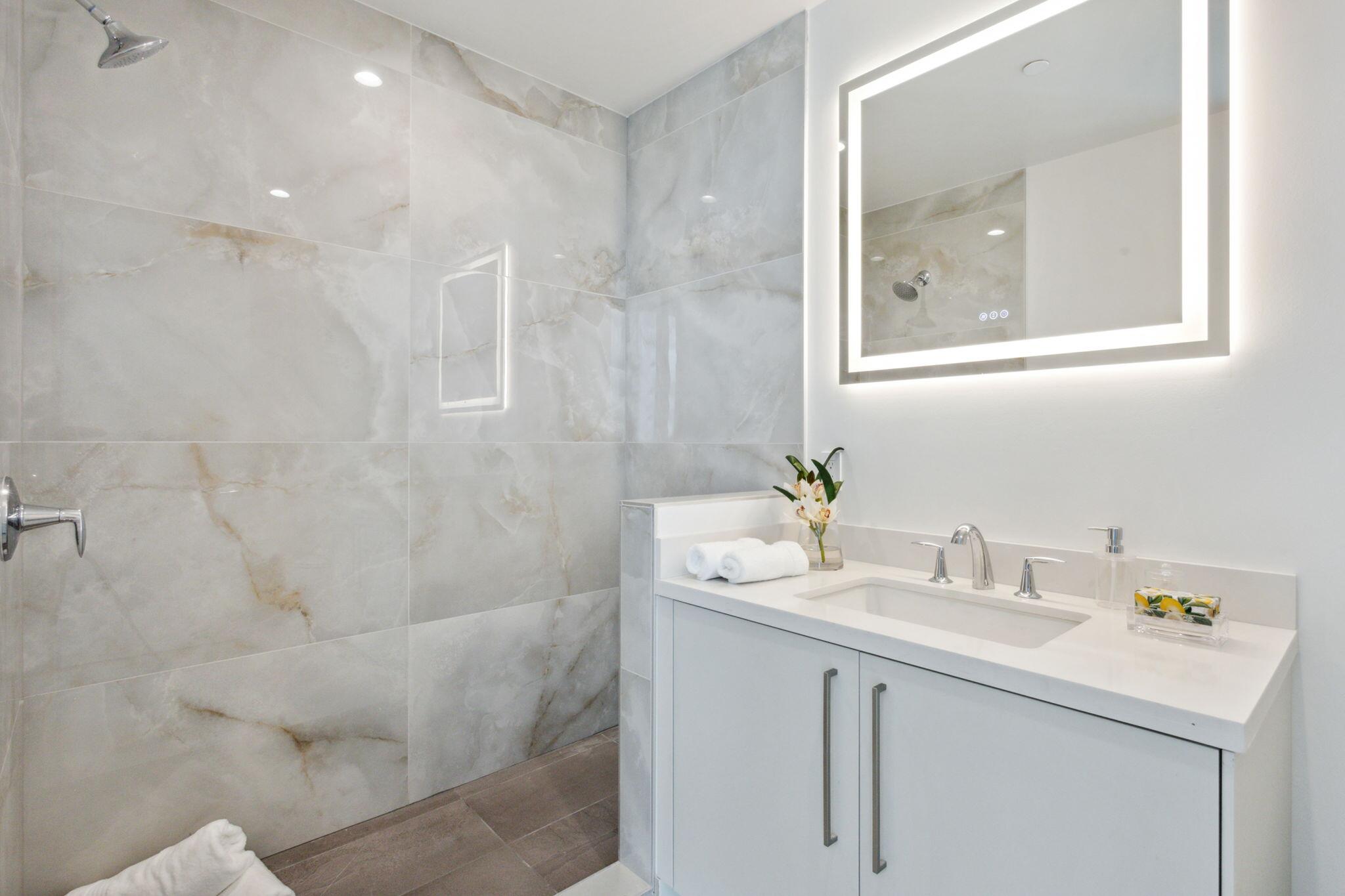 475 East Royal Palm Road, Unit 605 Boca Raton, FL 33432 - Photo 33 of 62 a bathroom with a sink mirror and a shower