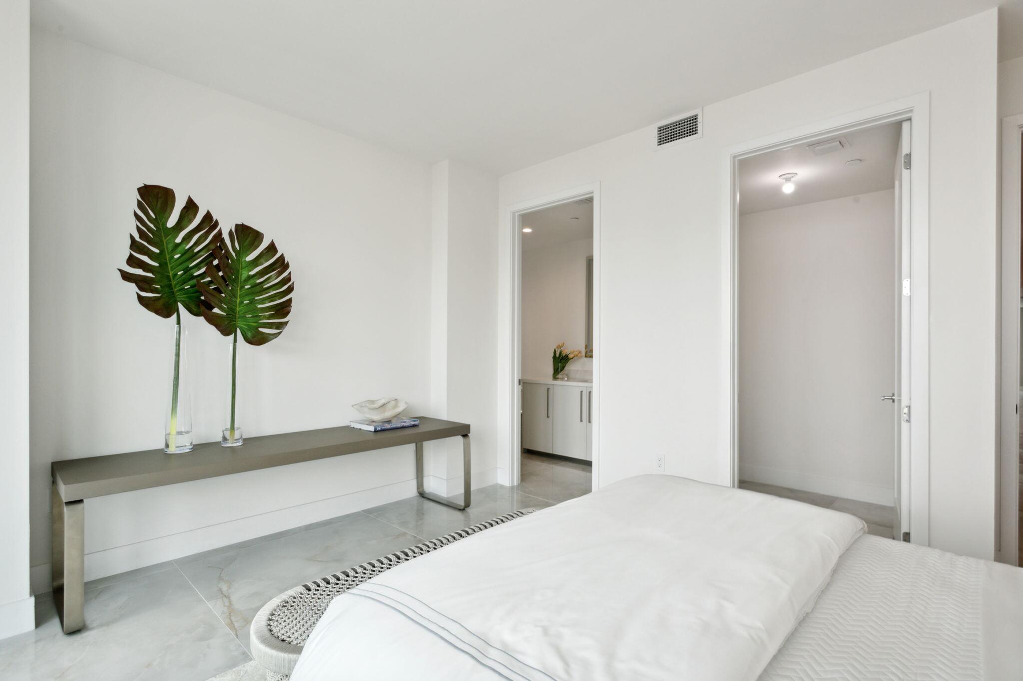 475 East Royal Palm Road, Unit 605 Boca Raton, FL 33432 - Photo 37 of 62 a bedroom with a bed and a potted plant