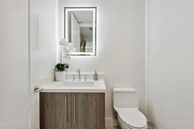 a dining room with furniture a chandelier and wooden floor