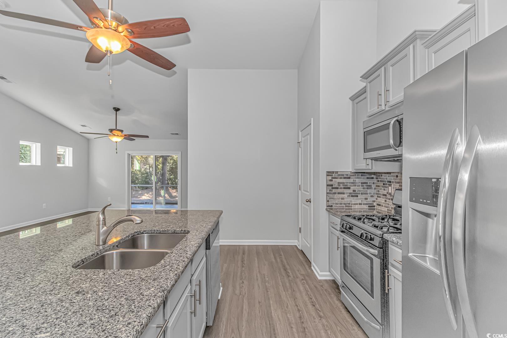 4348 Livorn Loop, Unit 4348 Myrtle Beach, SC 29579 - Photo 12 of 38 Kitchen featuring sink, light stone counters, vaul