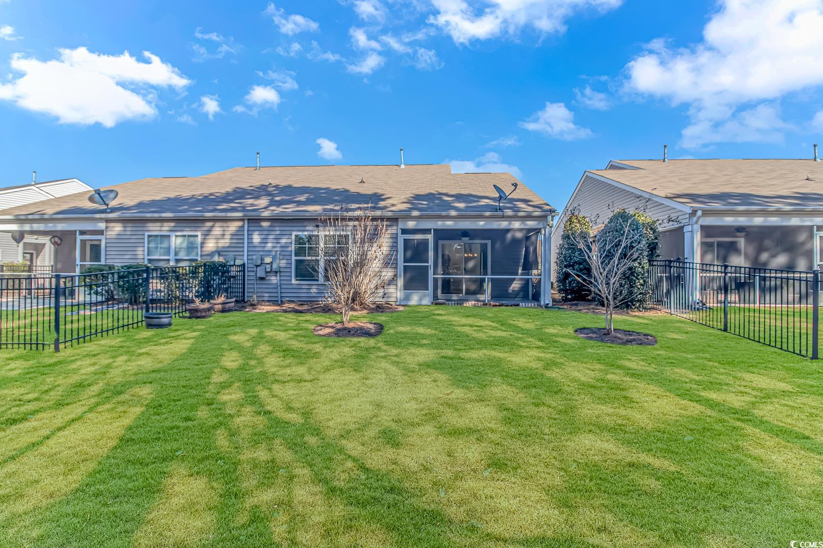4348 Livorn Loop, Unit 4348 Myrtle Beach, SC 29579 - Photo 28 of 38 Rear view of property with a yard and a sunroom