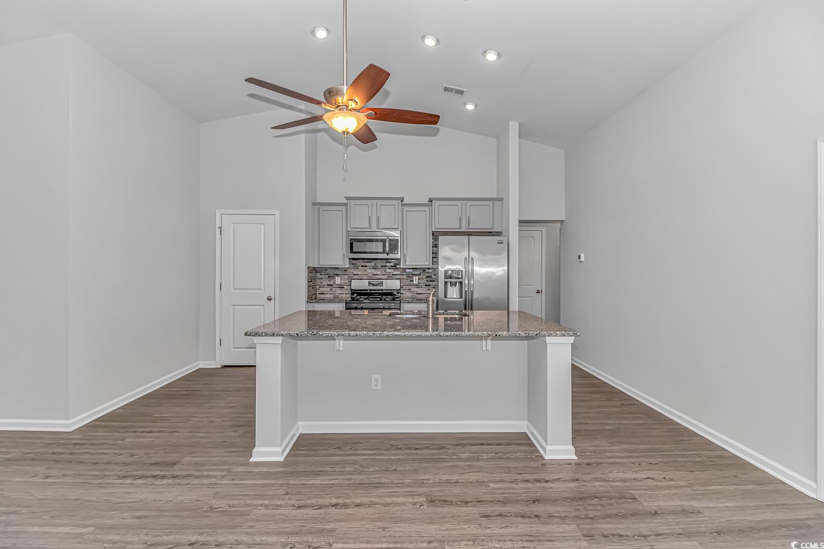 4348 Livorn Loop, Unit 4348 Myrtle Beach, SC 29579 - Photo 5 of 38 Kitchen featuring a kitchen bar, light stone count