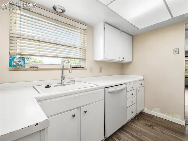 a kitchen with sink cabinets and window