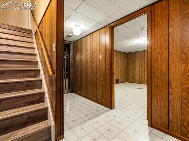 a view of a hallway with wooden floor and entryway