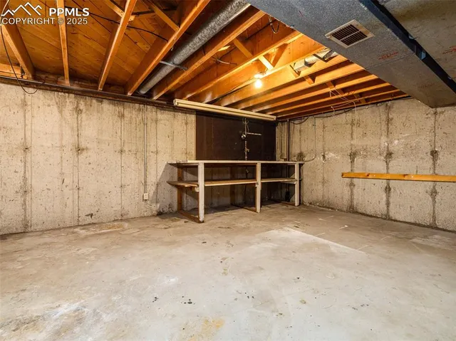 an empty room with wooden floor and window