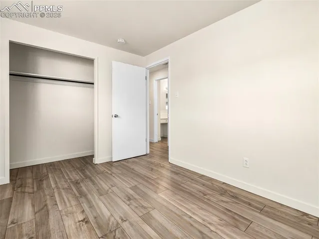 a view of an empty room and wooden floor