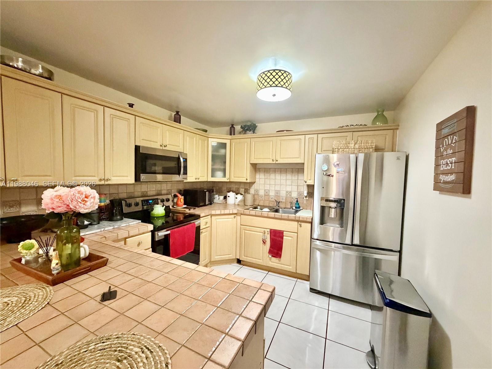 14474 Southwest 293rd Terrace Homestead, FL 33033 - Photo 8 of 20 a kitchen with granite countertop a refrigerator stove top oven and sink