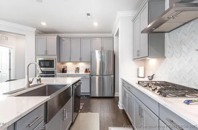 a kitchen with a sink stove and refrigerator