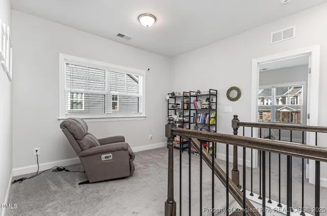 a bed room with furniture and a large window