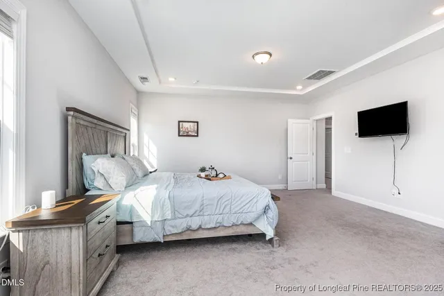 a bathroom with a glass shower door a sink and a mirror