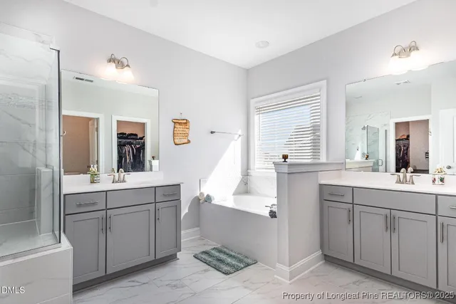 a view of walk in closet with clothes