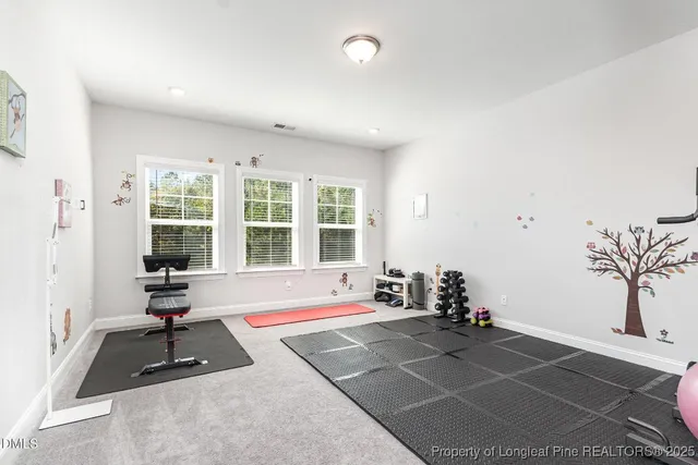 a spacious bedroom with a bed and a window