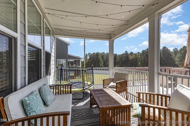 a view of a patio on wooden deck with a table and chairs
