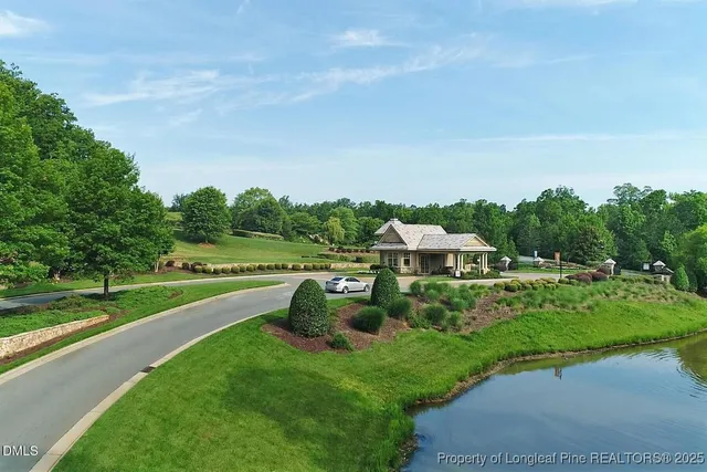 a view of a house with swimming pool and sitting area