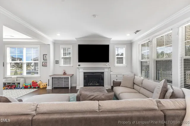 a living room with furniture fireplace and flat screen tv
