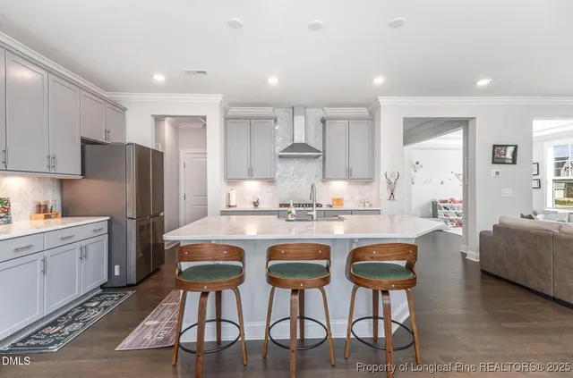 a kitchen with cabinets and chairs