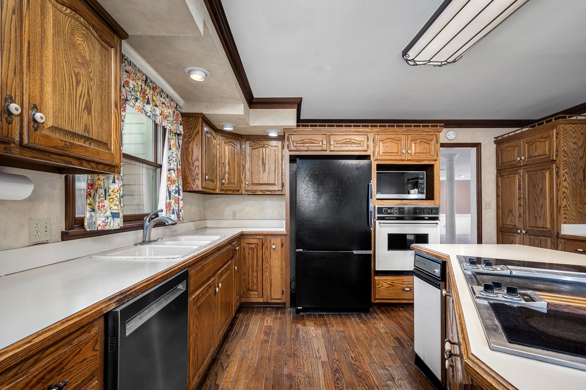 140 Motlow Road Tullahoma, TN 37388 - Photo 34 of 69 a kitchen with a refrigerator a sink and wooden floor