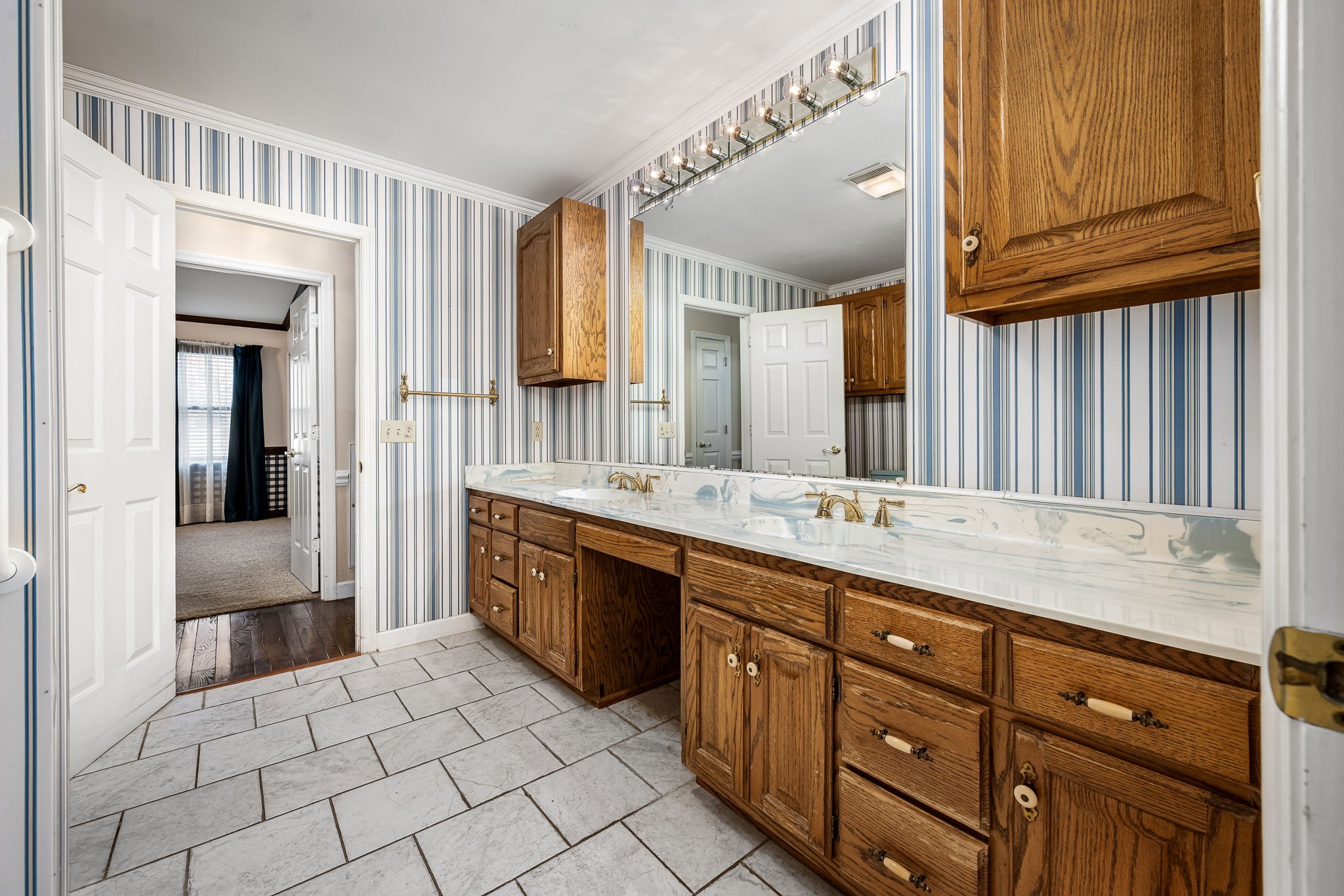 140 Motlow Road Tullahoma, TN 37388 - Photo 44 of 69 a spacious bathroom with a granite countertop sink and a mirror