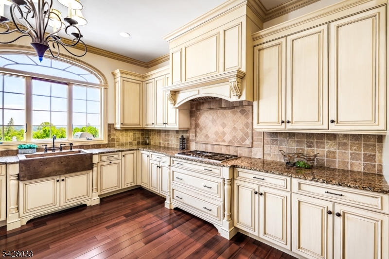 2 Chilton Road Chester, NJ 07930 - Photo 10 of 43 a kitchen with stainless steel appliances granite countertop a stove a sink and white cabinets
