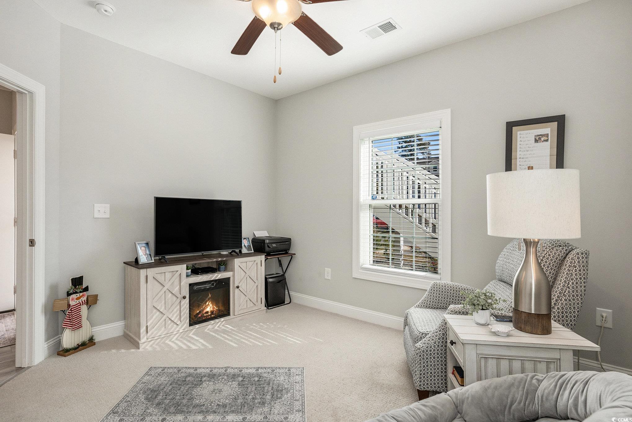 932 Jackline Place, Unit 101 Murrells Inlet, SC 29576 - Photo 25 of 40 Bedroom featuring light carpet, a ceiling fan