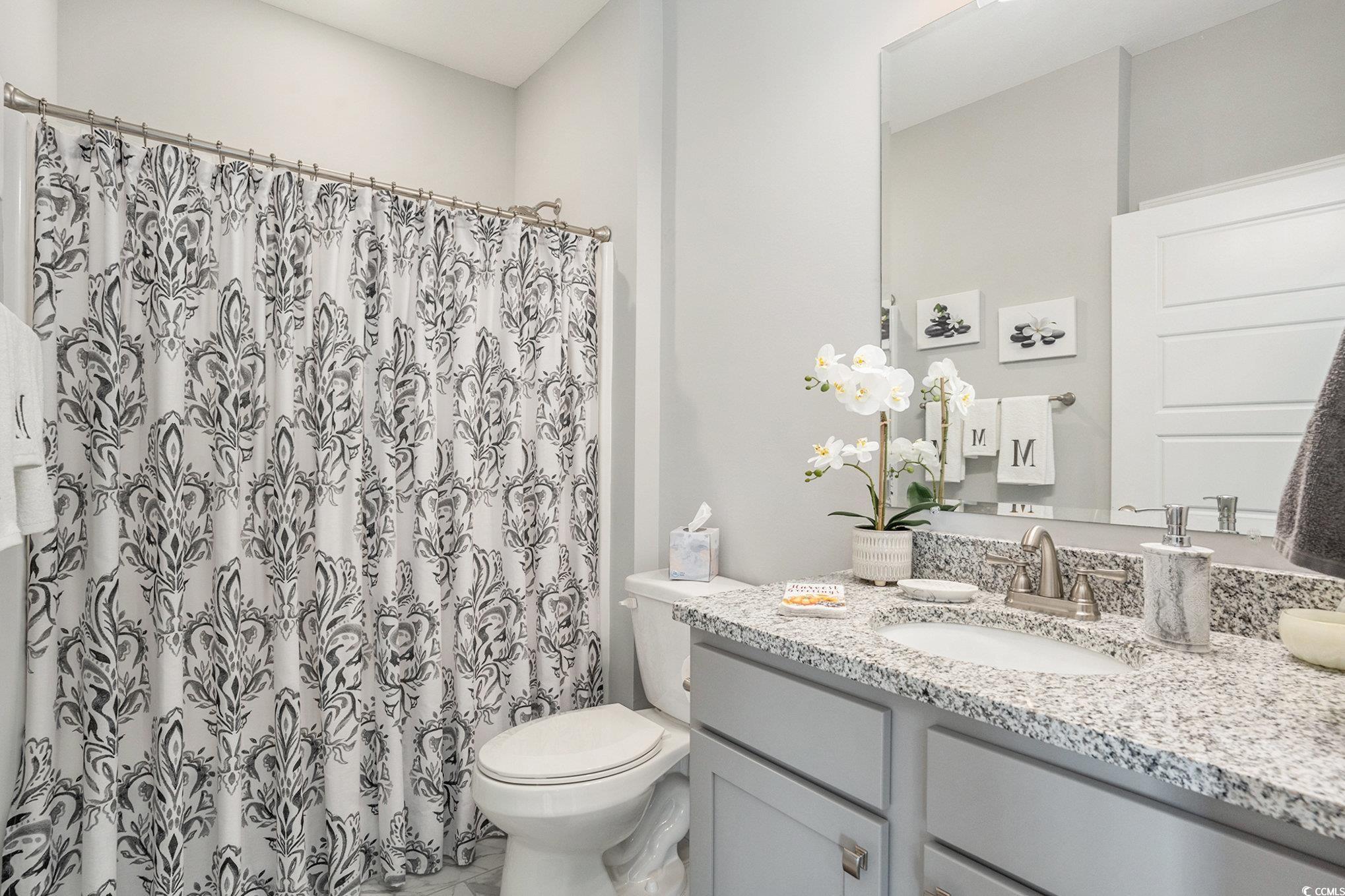 932 Jackline Place, Unit 101 Murrells Inlet, SC 29576 - Photo 27 of 40 Full bath featuring vanity and a shower with shower curtain