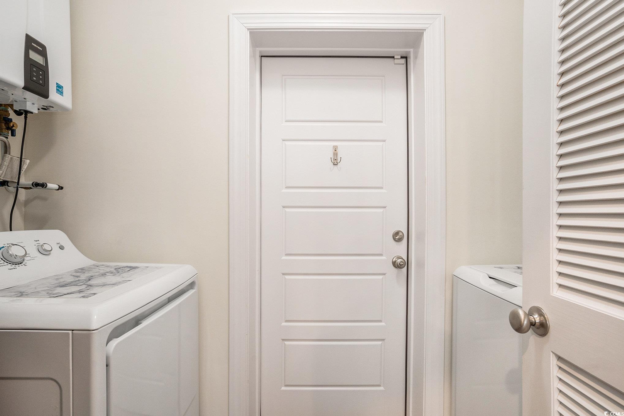 932 Jackline Place, Unit 101 Murrells Inlet, SC 29576 - Photo 28 of 40 Washroom with tankless water heater and washing machine and dryer