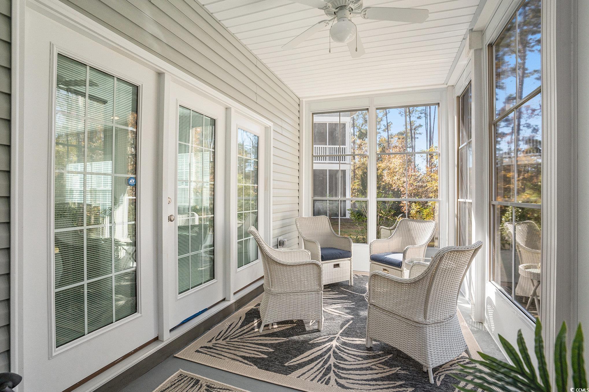 932 Jackline Place, Unit 101 Murrells Inlet, SC 29576 - Photo 3 of 40 Sunroom / solarium with a ceiling fan and outdoor lounge area