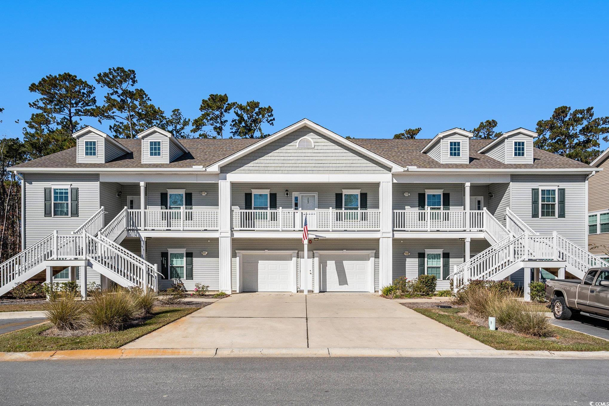 932 Jackline Place, Unit 101 Murrells Inlet, SC 29576 - Photo 32 of 40 Beach home featuring stairs, covered porch, driveway, and an attached garage