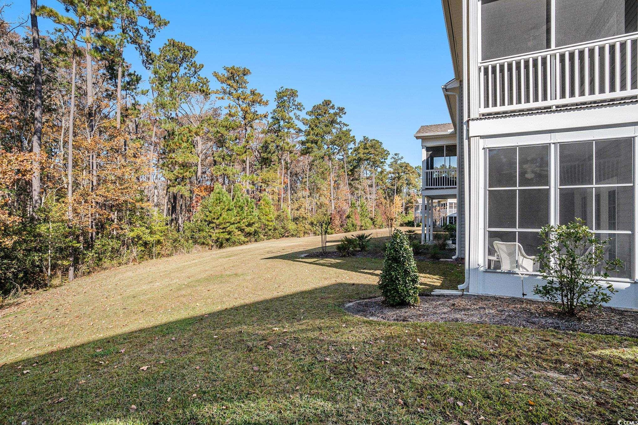 932 Jackline Place, Unit 101 Murrells Inlet, SC 29576 - Photo 34 of 40 View of green lawn with a balcony