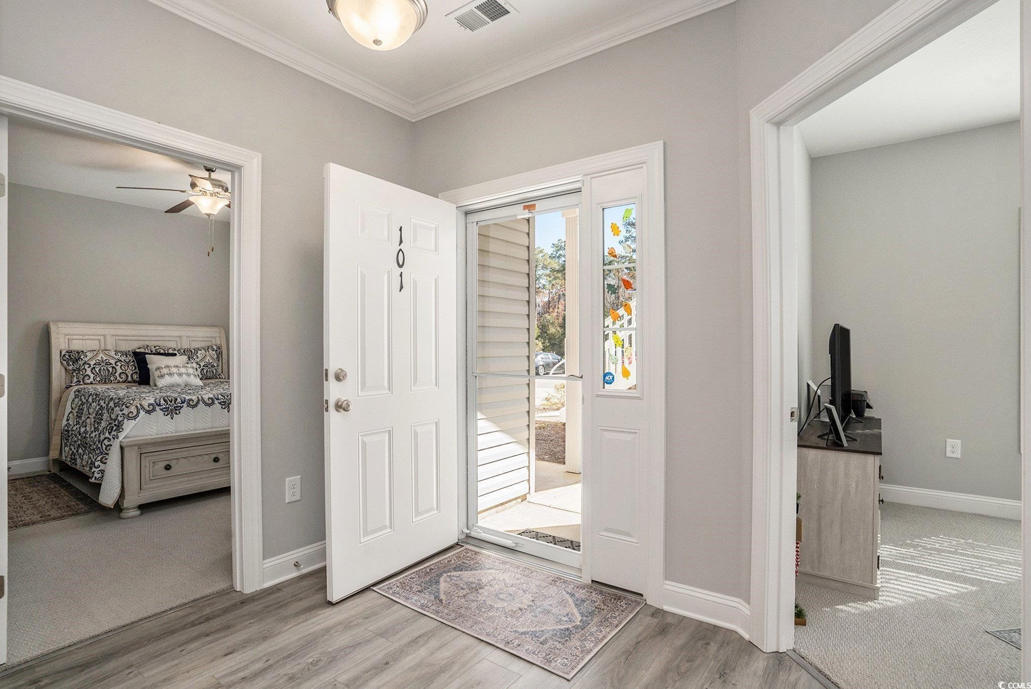 932 Jackline Place, Unit 101 Murrells Inlet, SC 29576 - Photo 9 of 40 Foyer entrance with ornamental molding, light wood-type flooring, and ceiling fan