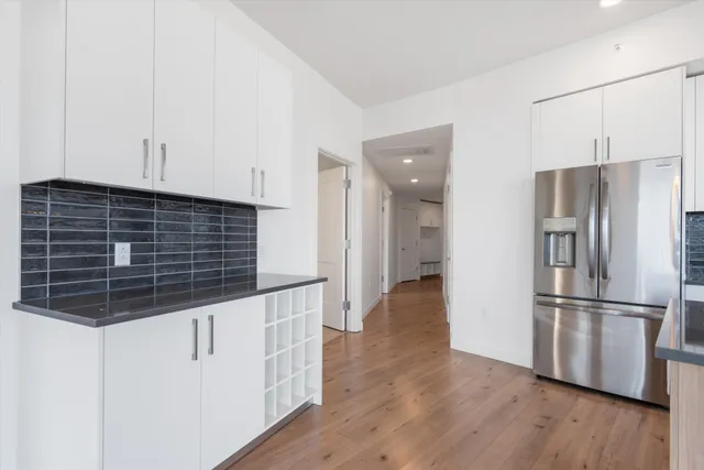 a view of front door with living room and floor to ceiling window
