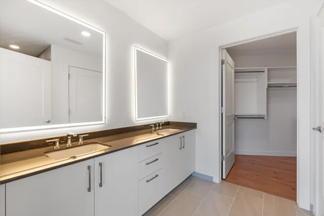 a hallway with sink and mirror