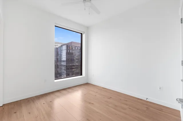 a bathroom with a granite countertop sink a toilet a mirror and bathtub