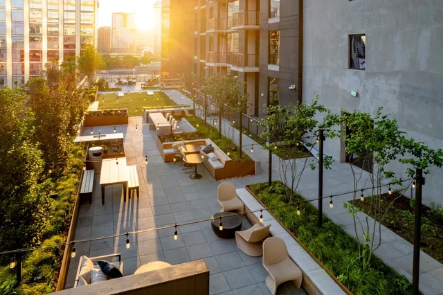a view of a patio with a table and chairs and couches with wooden floor