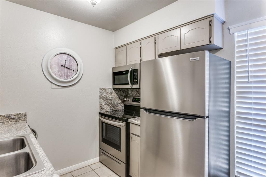4022 Ridglea Country Club Drive, Unit 608 Fort Worth, TX 76126 - Photo 15 of 28 a kitchen with stainless steel appliances granite countertop a refrigerator and a sink