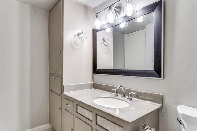 a bathroom with a sink vanity and a mirror