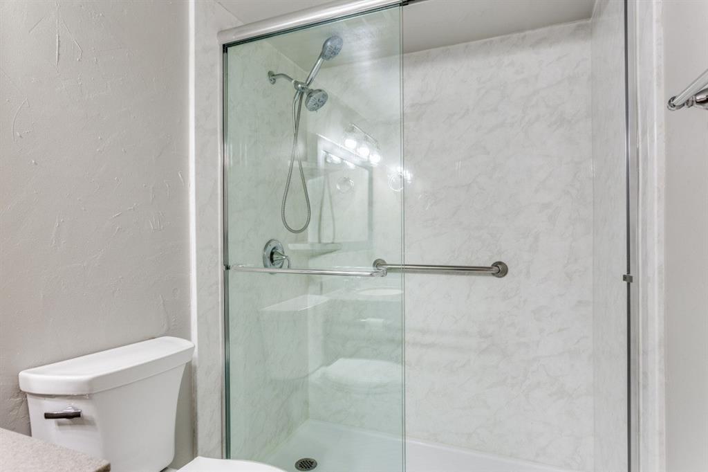 4022 Ridglea Country Club Drive, Unit 608 Fort Worth, TX 76126 - Photo 23 of 28 a bathroom with a shower and toilet