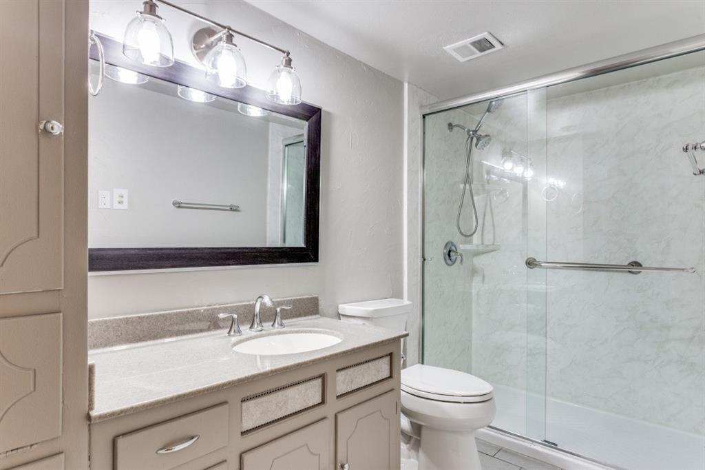 4022 Ridglea Country Club Drive, Unit 608 Fort Worth, TX 76126 - Photo 24 of 28 a bathroom with a sink toilet a mirror and shower