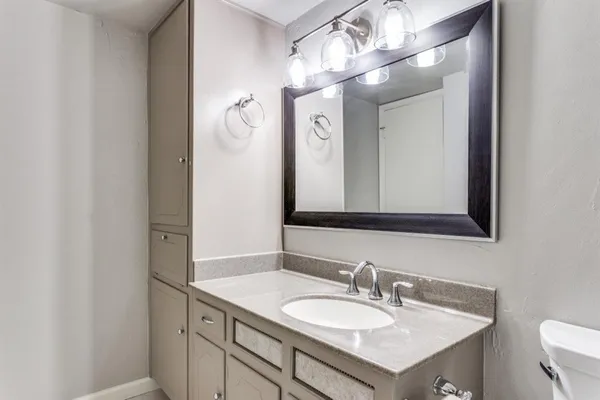 a bathroom with a sink vanity and a mirror