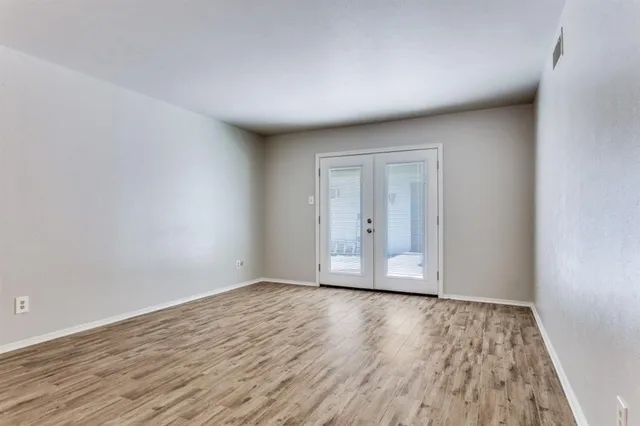 a view of an empty room and wooden floor