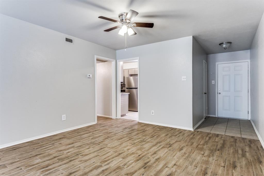4022 Ridglea Country Club Drive, Unit 608 Fort Worth, TX 76126 - Photo 9 of 28 a view of empty room with wooden floor and fan