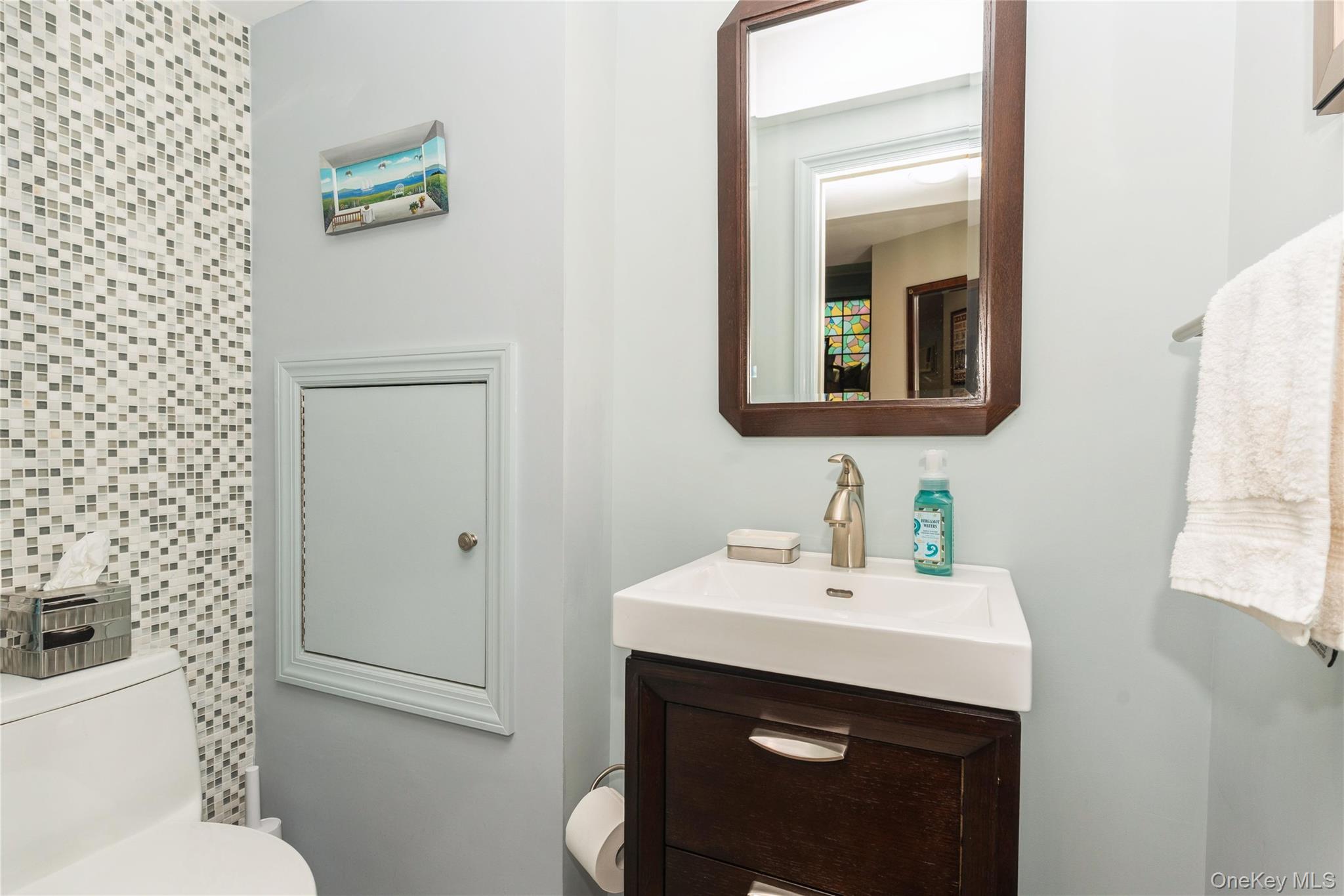 2772 Riverside Avenue Merrick, NY 11566 - Photo 20 of 45 a bathroom with a sink and a mirror
