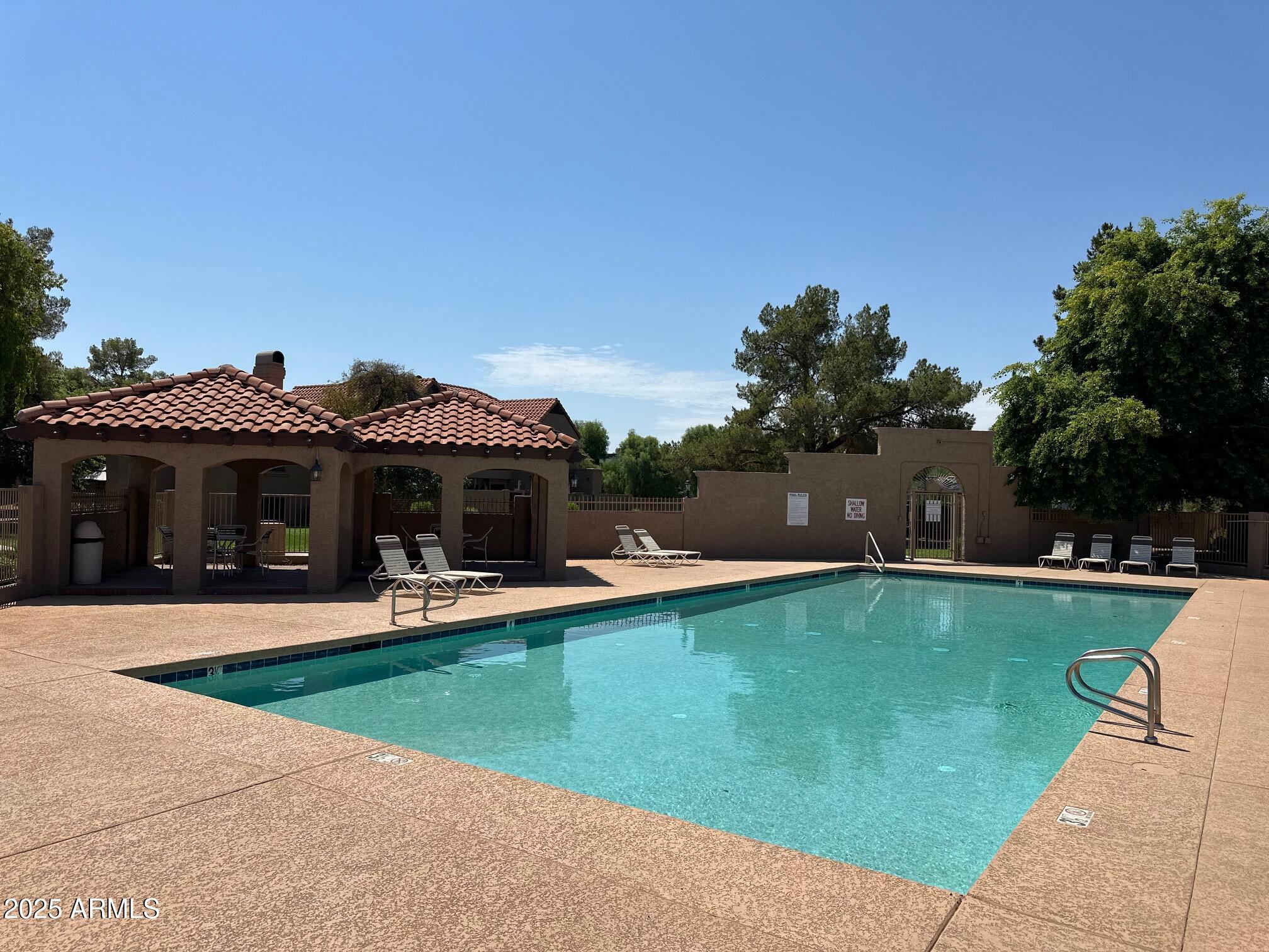 3491 North Arizona Avenue, Unit 20 Chandler, AZ 85225 - Photo 1 of 13 a view of a house with swimming pool and a yard
