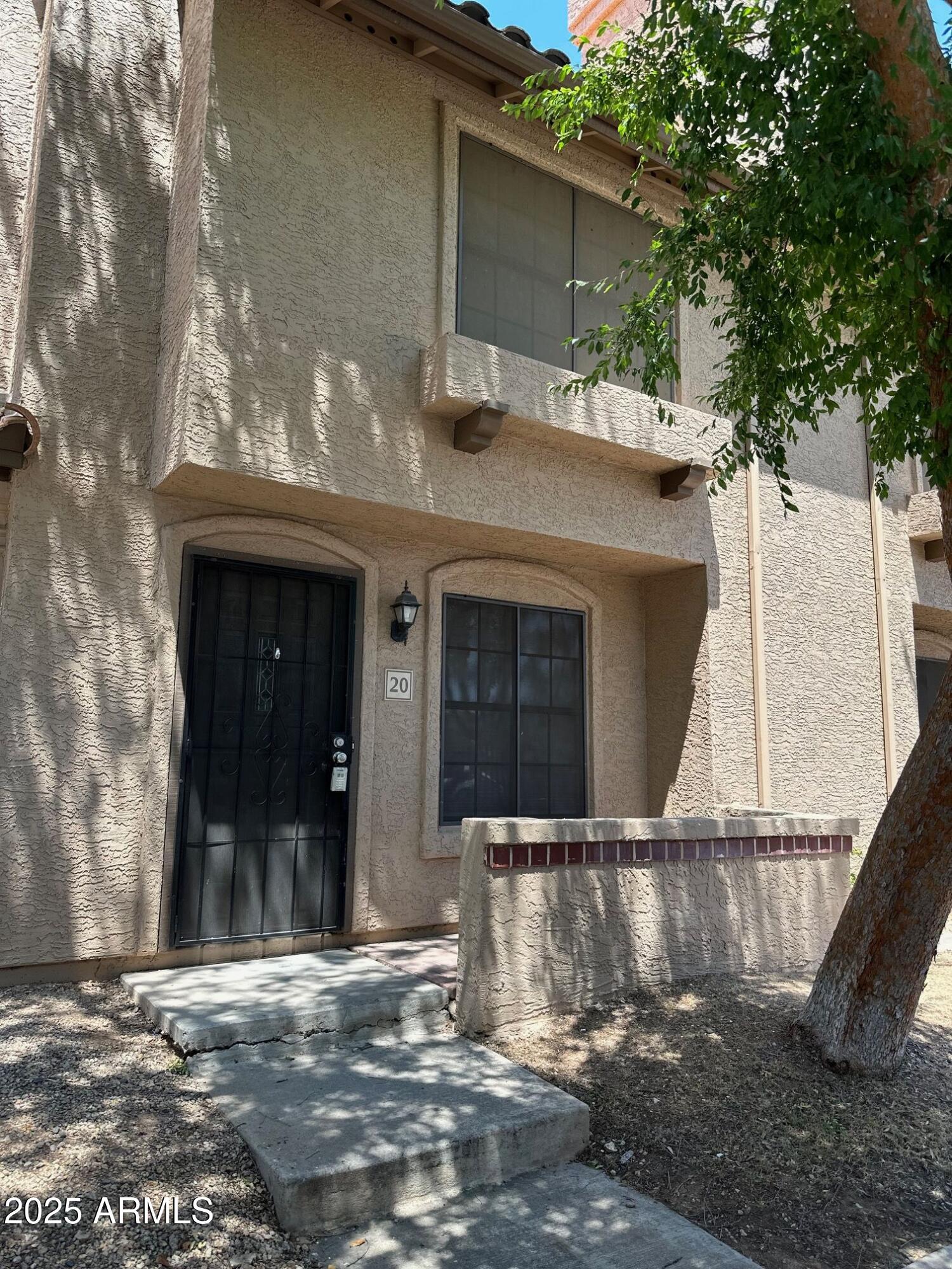 3491 North Arizona Avenue, Unit 20 Chandler, AZ 85225 - Photo 2 of 13 a view of a house with a door and a large tree