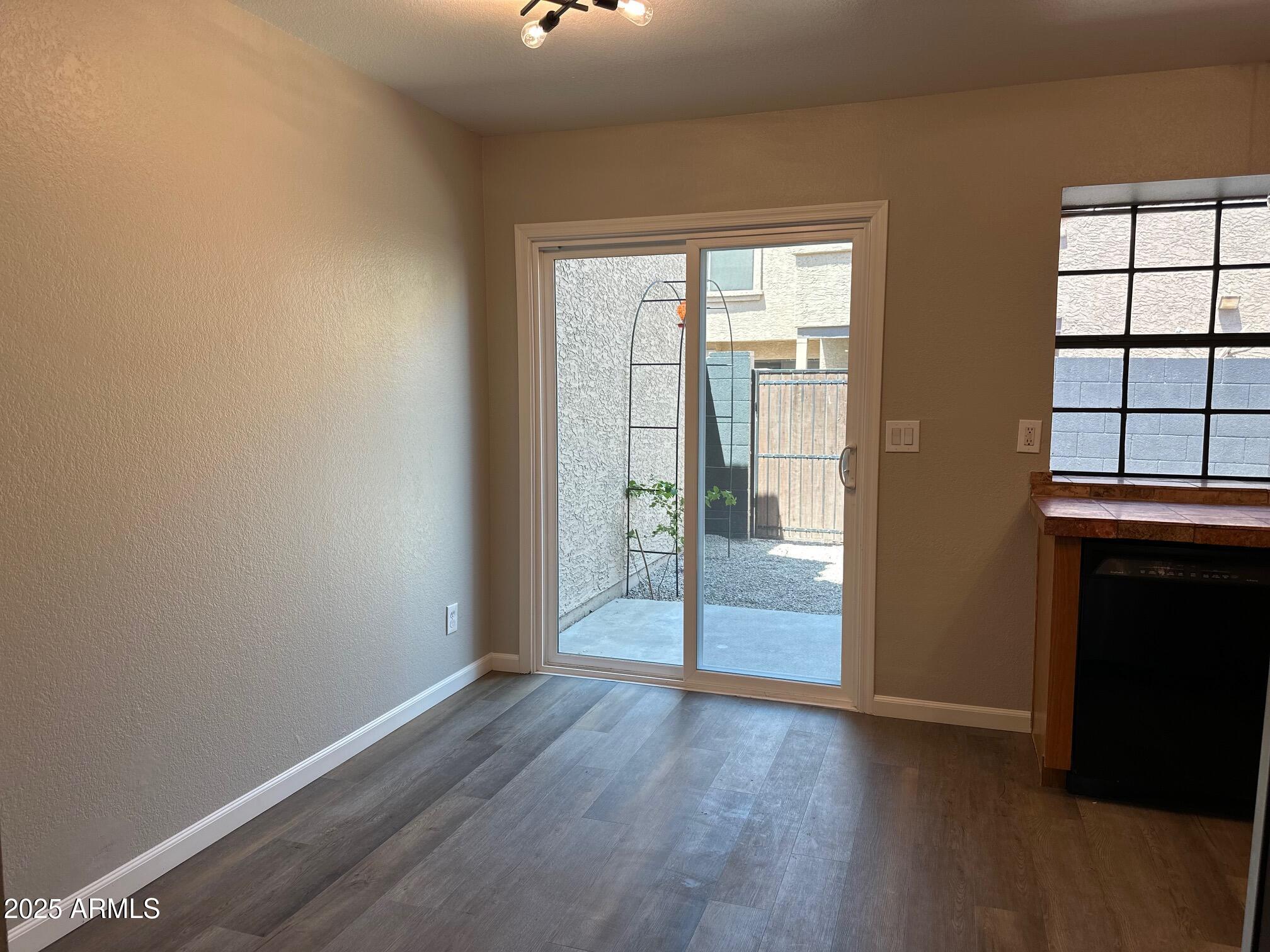 3491 North Arizona Avenue, Unit 20 Chandler, AZ 85225 - Photo 5 of 13 wooden floor in an empty room with a window